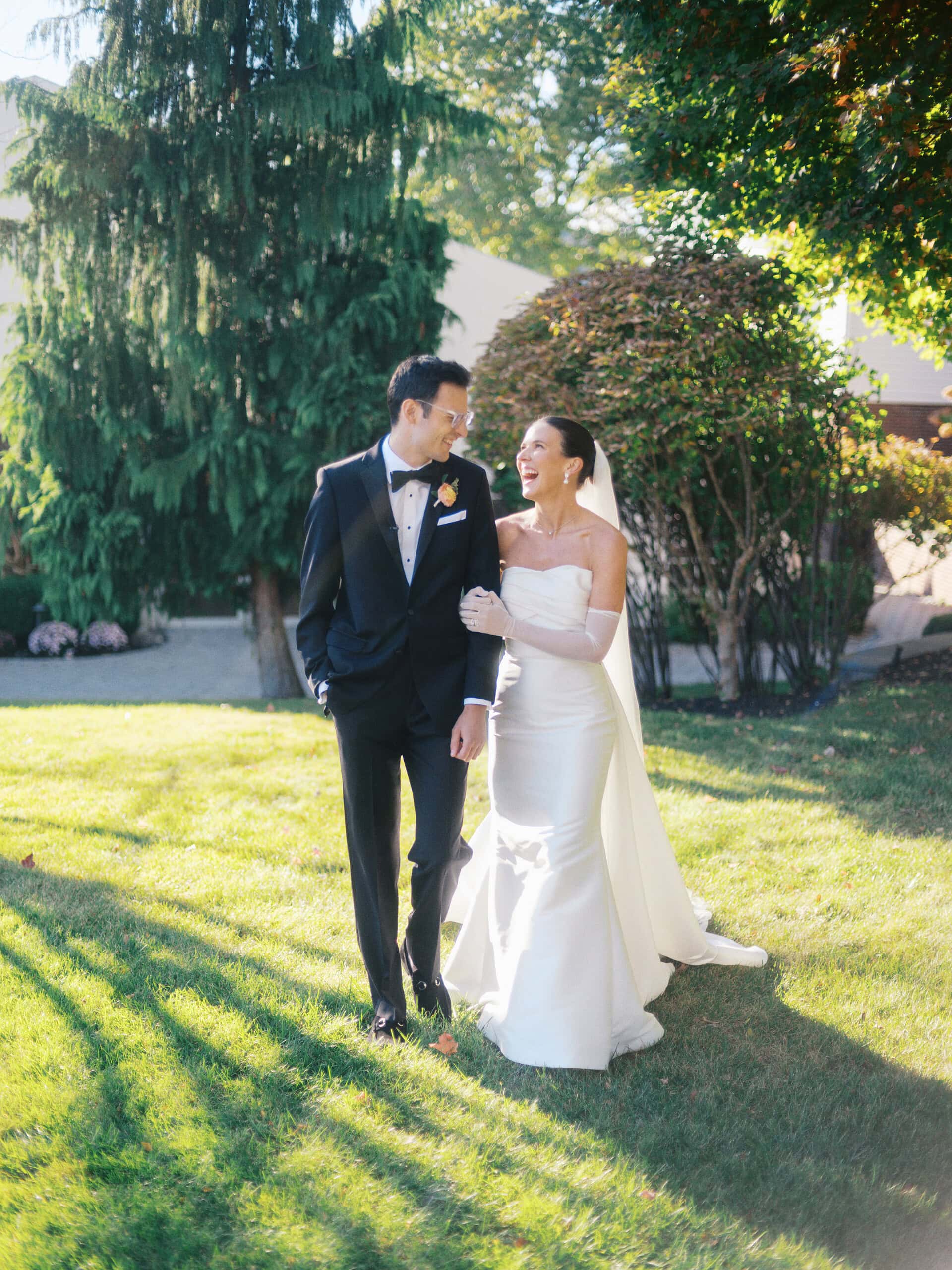 Elizabeth and Matt walking together and laughing through the grounds at The Grandview Poughkeepsie NY