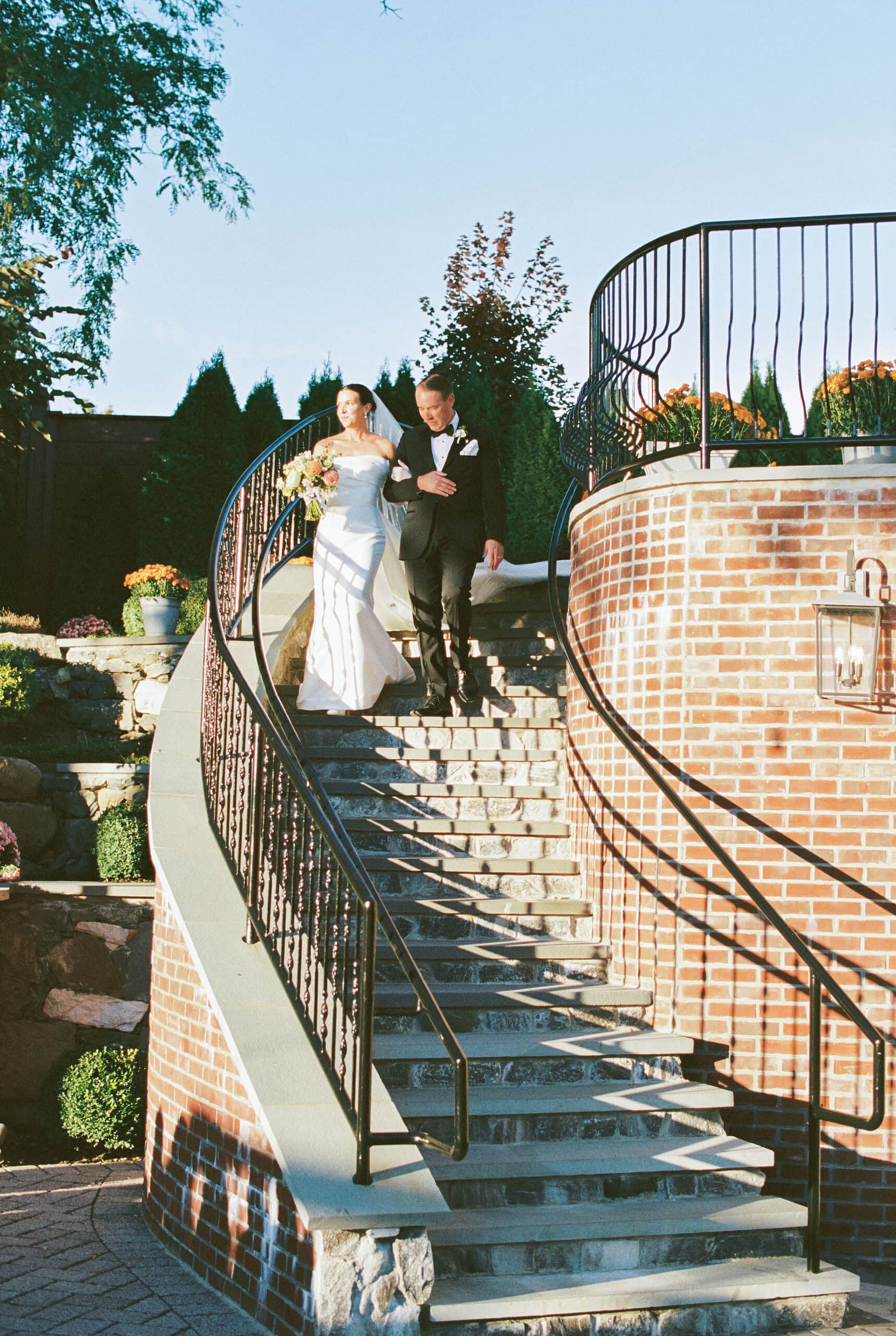Elizabeth and Matt descending The Grandview's iconic curved brick staircase together after the ceremony — film wedding photography Poughkeepsie NY