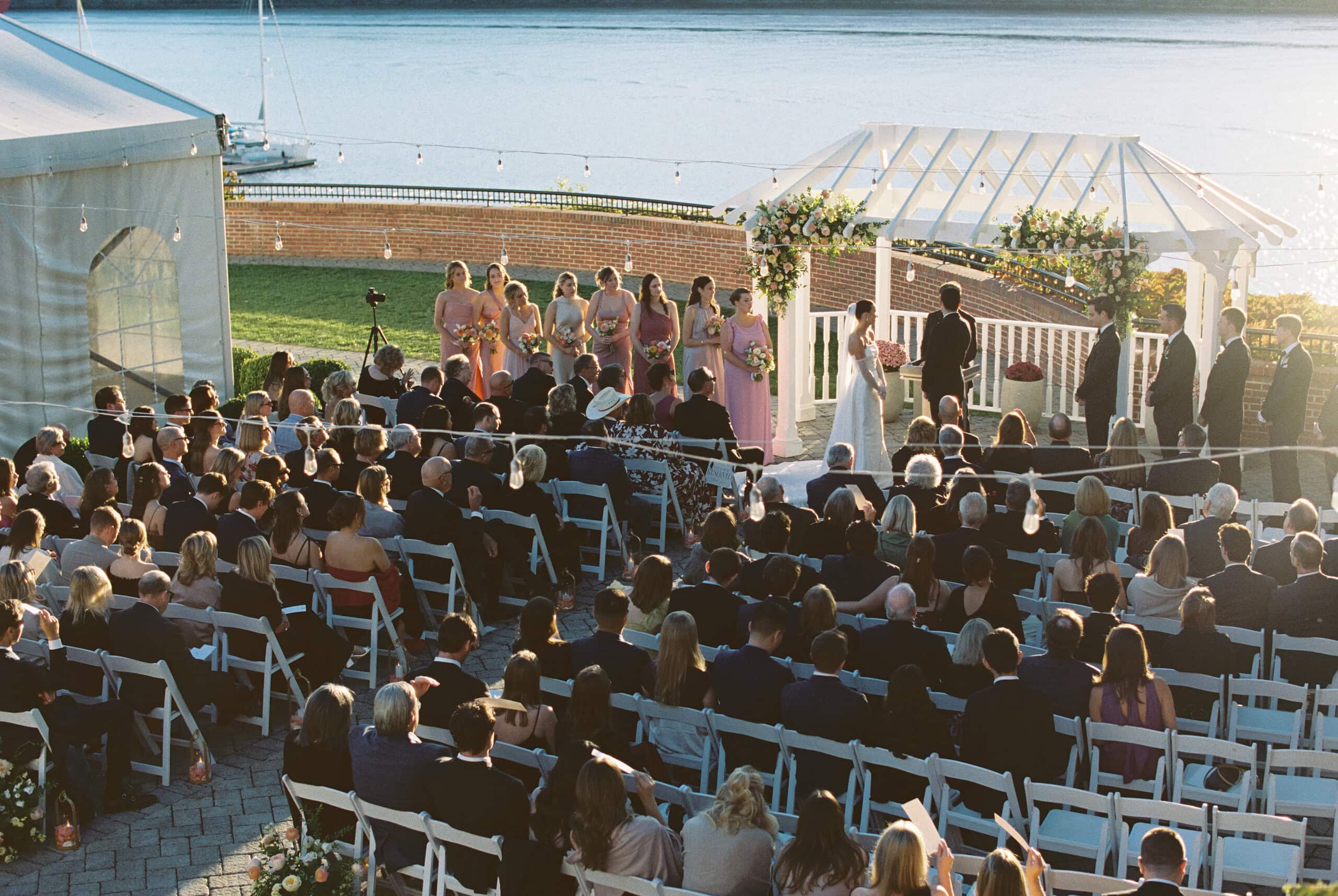 Aerial wide shot of full outdoor wedding ceremony at The Grandview Poughkeepsie NY — guests, bridal party, Hudson River backdrop — film photography