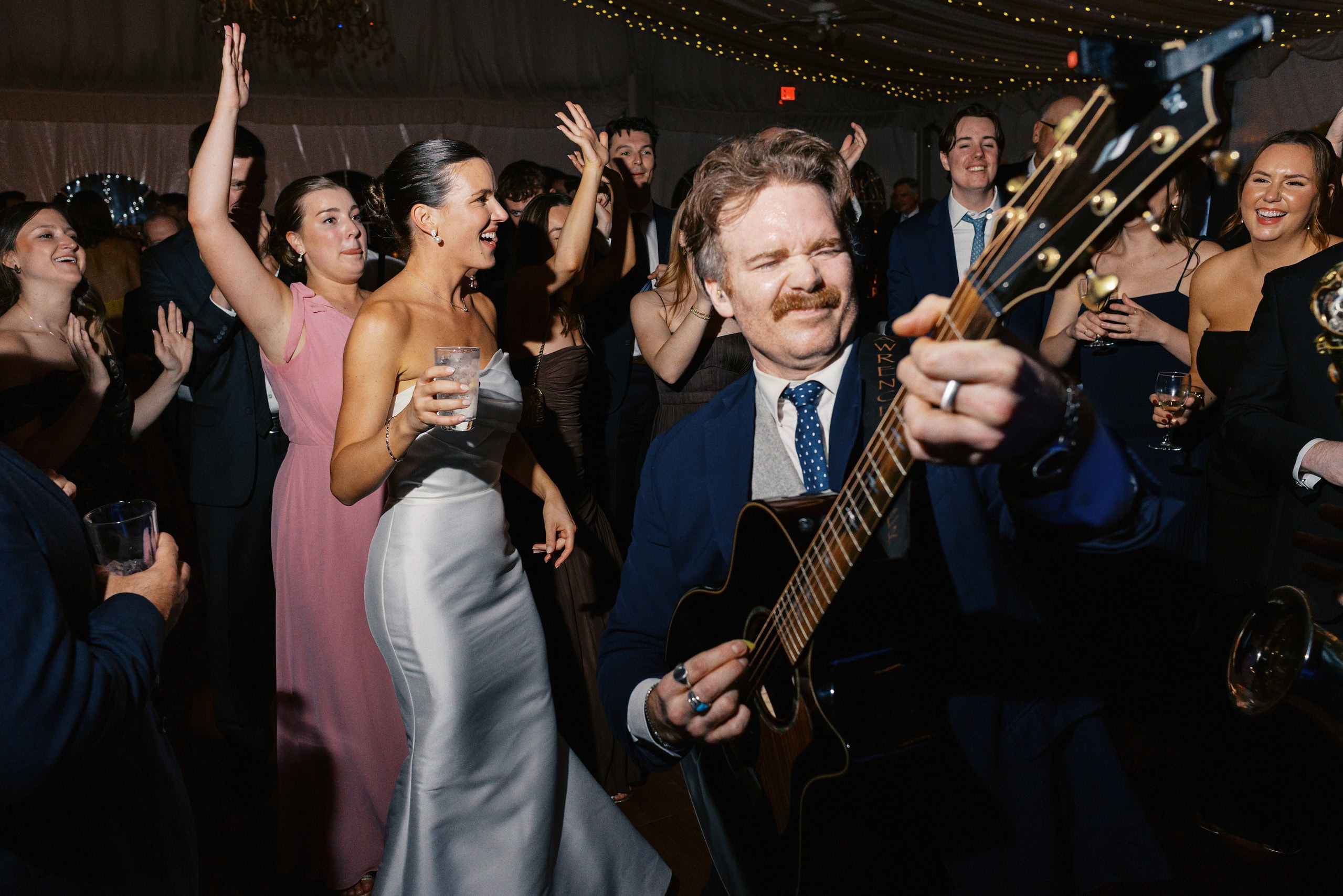Band guitarist playing on the packed dance floor at The Grandview wedding reception in Poughkeepsie NY — guests dancing and celebrating